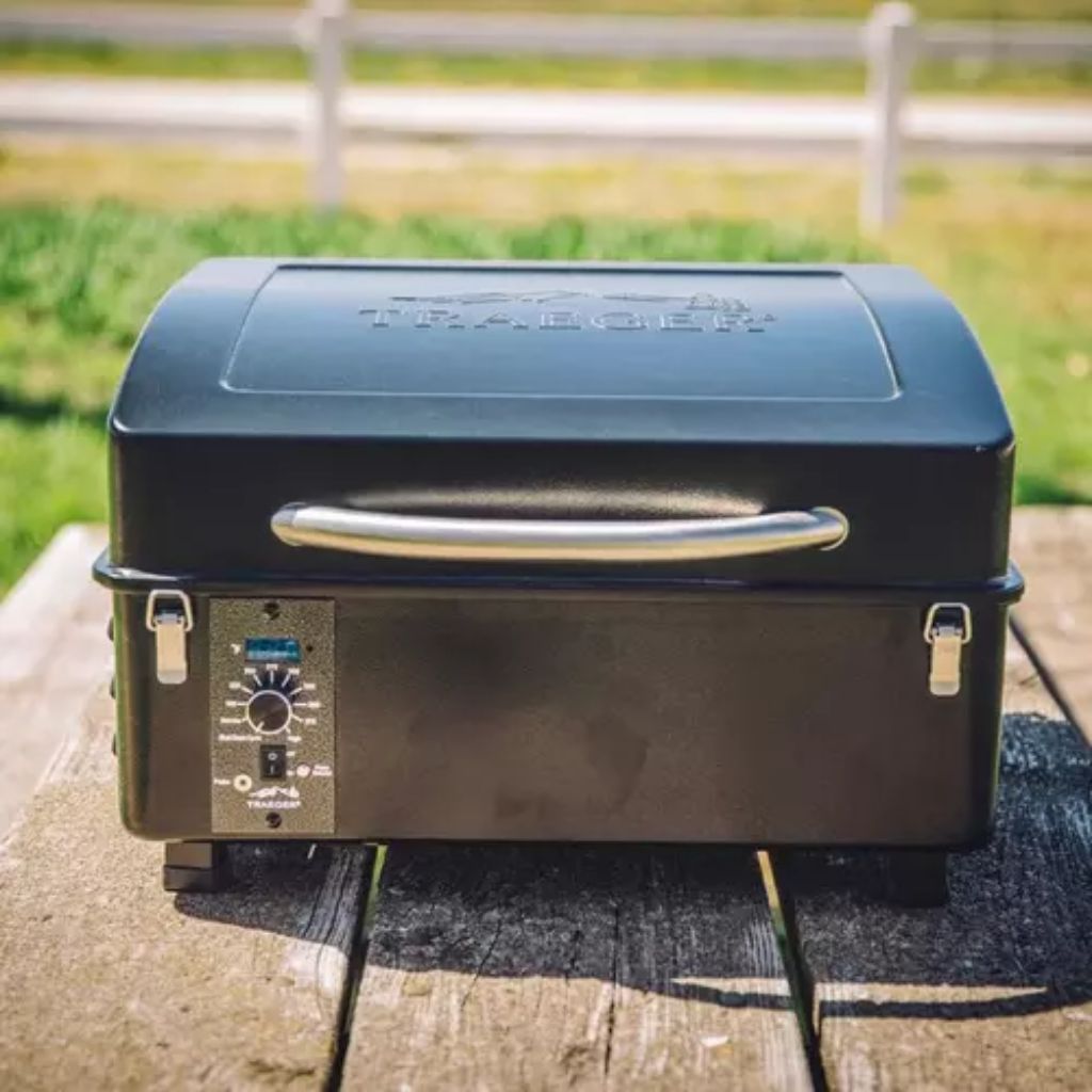 https://www.russellfeed.com/cdn/shop/products/traeger-scout-pellet-grill-lifestyle-front-angle_1024x1024.jpg?v=1599665668